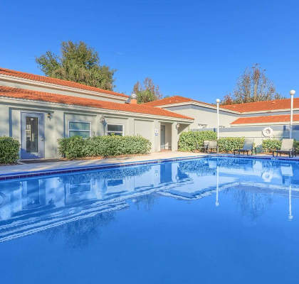 a swimming pool with a building in the background at Oak Chase II, Tampa, 33612