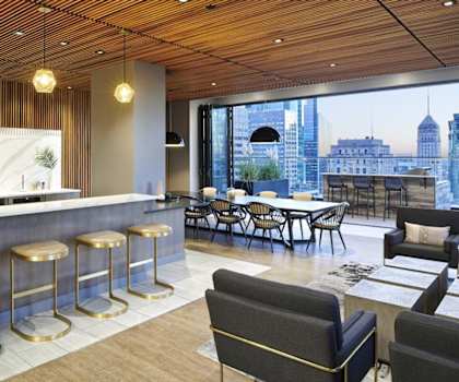 A bar and seating area in the lounge with a view of the city at 4Marq. 