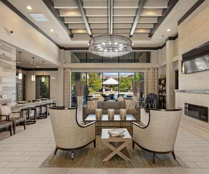 a living room with a table and chairs and a fireplace