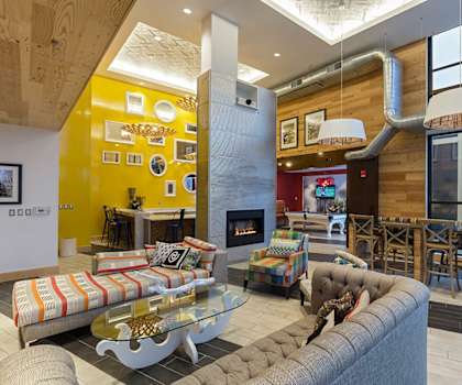 a living room with couches and chairs and a fireplace