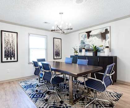 A dining room with a wooden table and blue chairs.