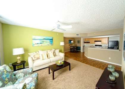 a living room with green walls and a white couch