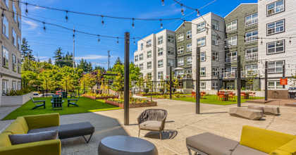 A patio with a lot of chairs and tables.
