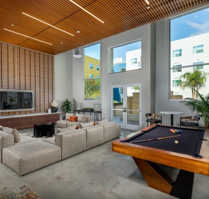 a living room with a pool table and a couch