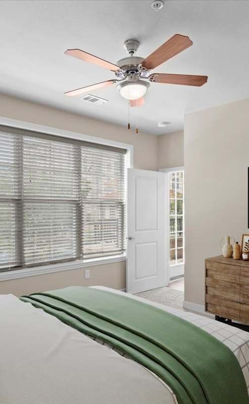 a bedroom with a bed and a ceiling fan at The Dorset, Kansas City, MO