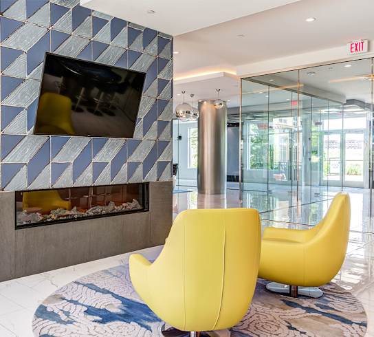 a living room with a fireplace and a tv on the wall at Ascend Apollo Apartments, Largo, Maryland