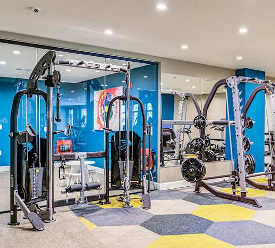 a workout room with a variety of exercise equipment at Aspire Apollo, Camp Springs, MD