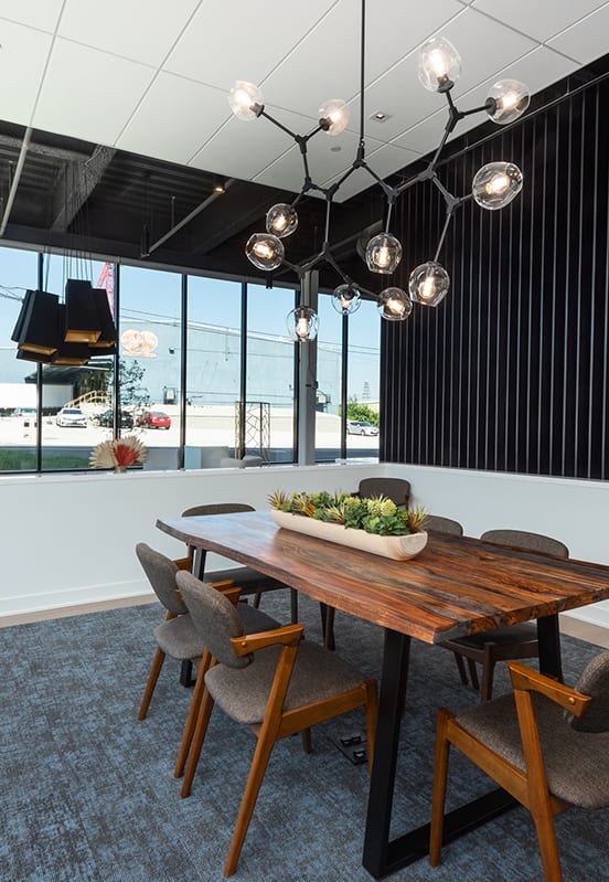 a dining room with a wooden table and chairs