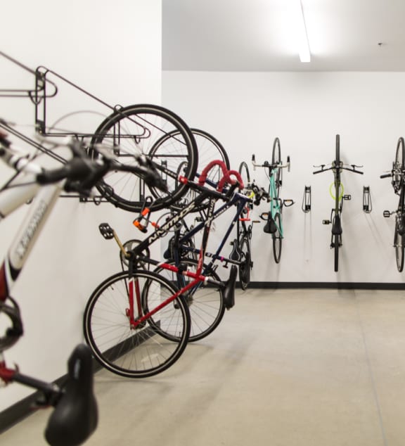 a group of bikes hanging on the wall in a white room at Pinnex, Indianapolis, IN, 46203