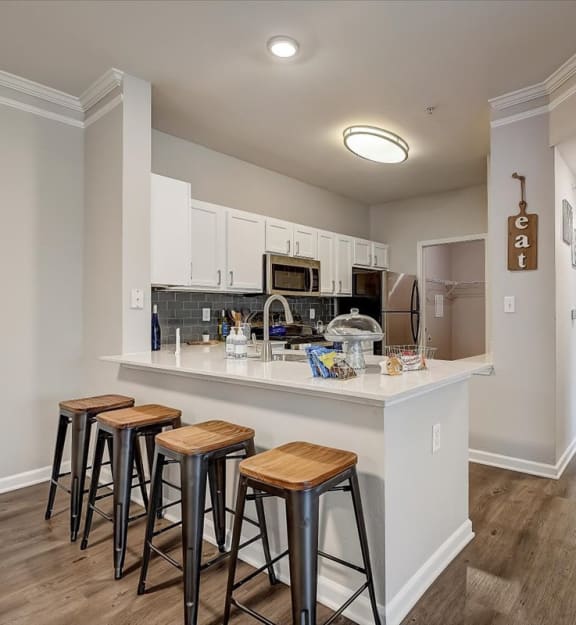 a kitchen with a breakfast bar and stools