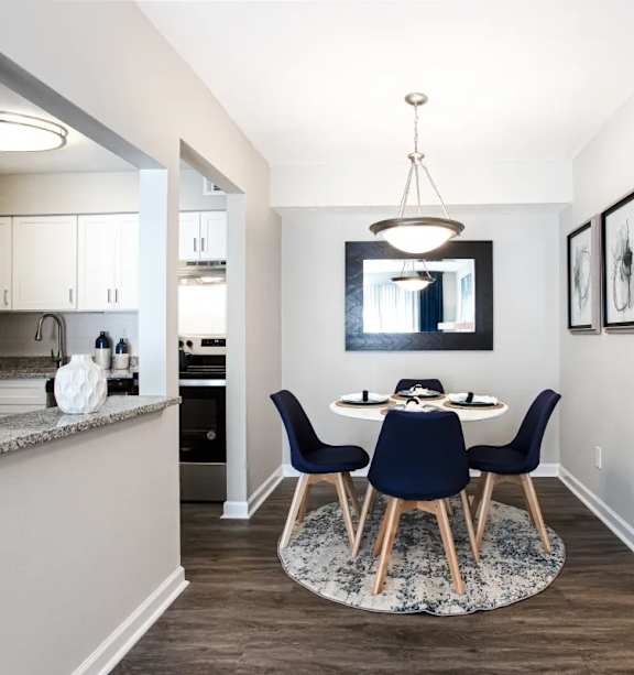 A modern dining room with a round table and chairs at Barcelo at East Cobb Apartments, GA, 30067