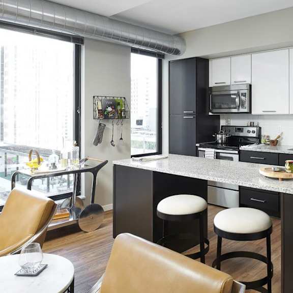 A kitchen with a countertop and a refrigerator at 4Marq. 