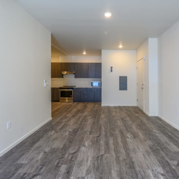 a living room with white walls and a wooden floor