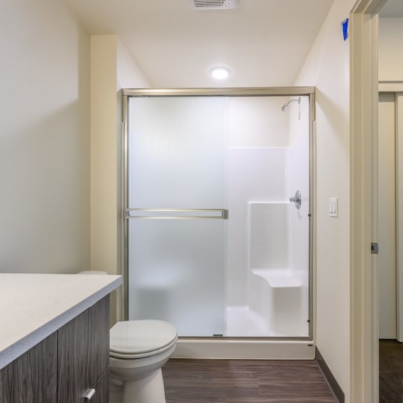 a bathroom with a toilet sink and shower