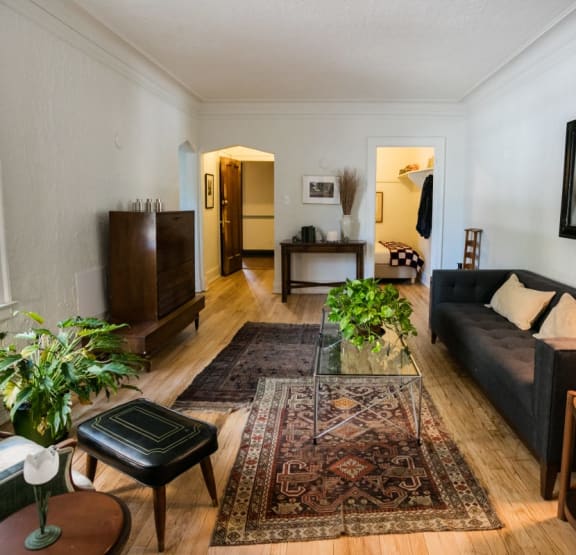a bedroom with a bed and bookshelves     and a chair