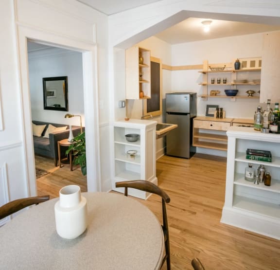 a kitchen with a wooden table and a stove and refrigerator
