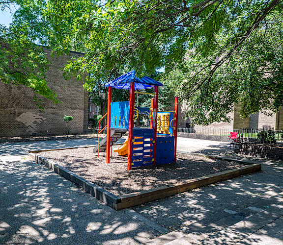 a playground with a blue and red swing set