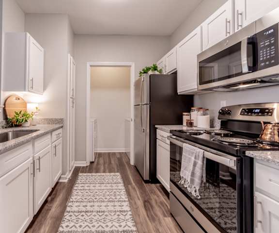 An open kitchen with white cabinets at The Village on Spring Mill, Carmel, Indiana