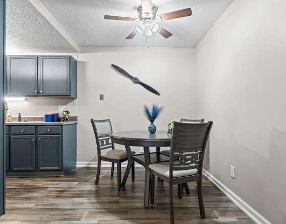 a dining room with a glass table and chairs