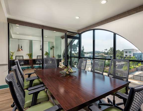 A conference room with a long table and chairs.