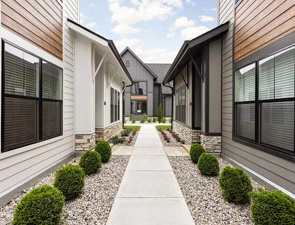 a row of houses with a sidewalk in front of them  at Slate at Fishers District, Fishers, IN