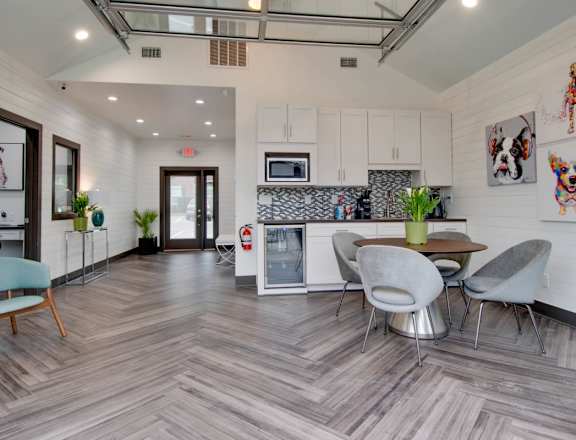A modern kitchen with a dining table and chairs.