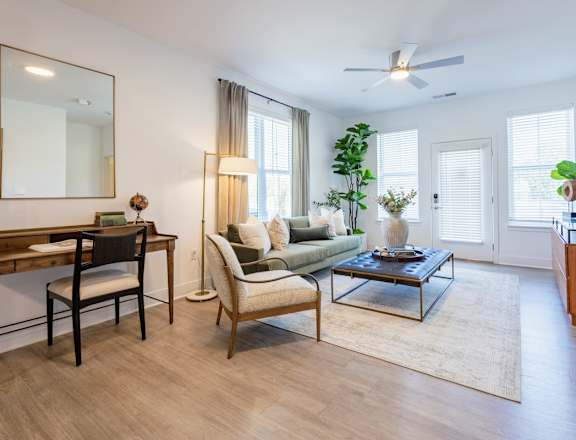 A living room with a couch, chair, and coffee table.