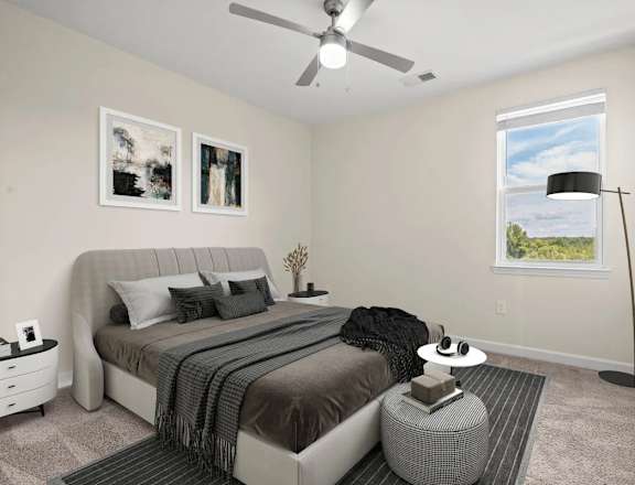 A bedroom with a large bed and a ceiling fan.