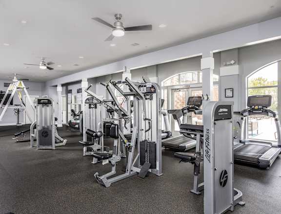 a gym with cardio machines and other exercise equipment