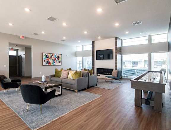 A modern living room with a pool table and a television.