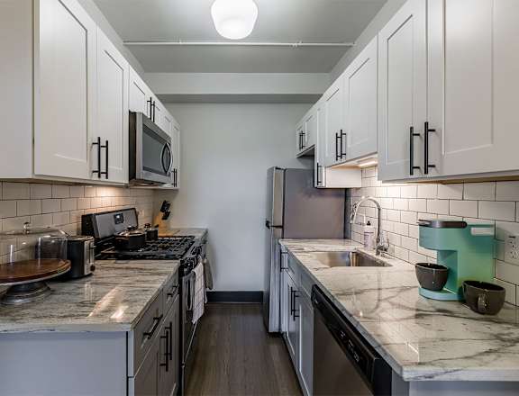 The Edison apartments kitchen with sleek cabinetry and stainless appliances