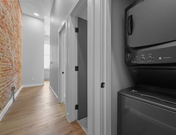 A black oven in a kitchen with white walls and wooden floors. at The Avenue Lofts Golden Apartments, Golden 80401