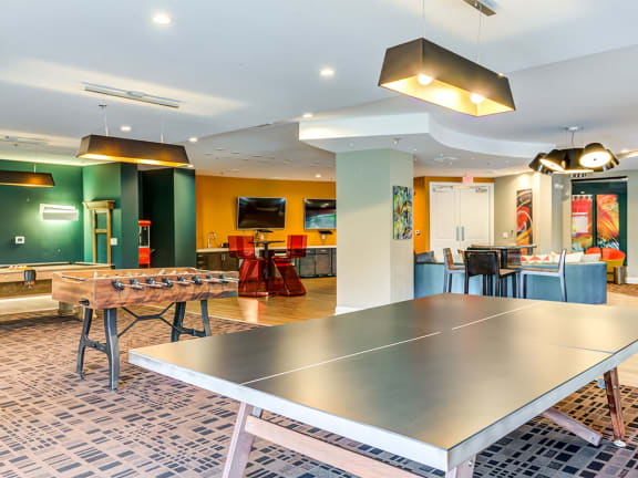a game room with a ping pong table and a foosball table
