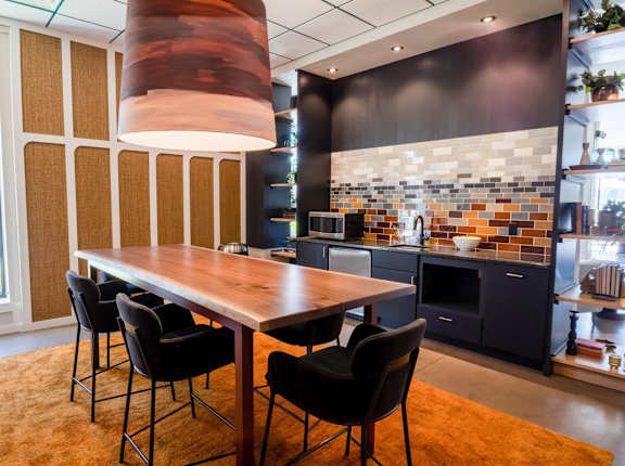 A modern kitchen with a dining table and chairs.