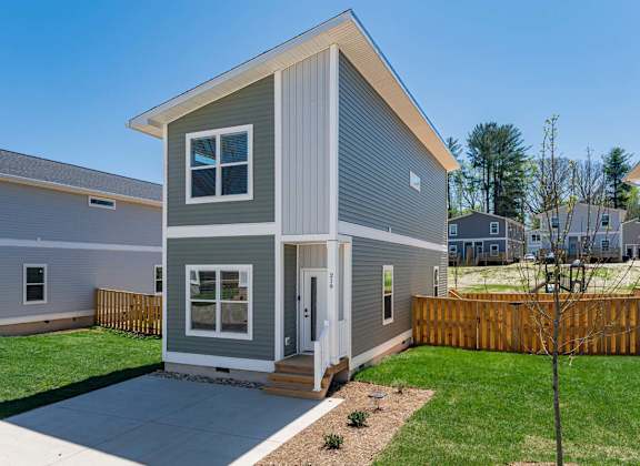 Pet-friendly home for rent in Asheville with fenced backyard, driveway, and modern exterior design.