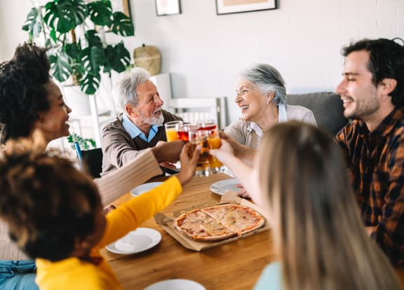 Lifestyle photo of family eating pizza at home at Sanctuary Cove, North Lauderdale, 33068