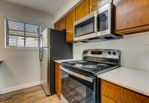 a kitchen with a stove microwave and refrigerator