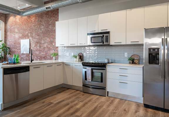 a kitchen with stainless steel appliances and white cabinets