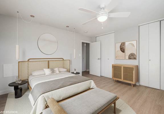 A bedroom with a large bed and a wooden headboard.