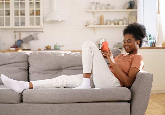 Lifestyle photo of woman at home on the couch at Villa Hermosa, Miami, FL, 33174