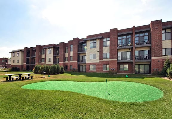 Putting green at Living room at Southfield MI Apartments | 42 West Apartments in Southfield Michigan
