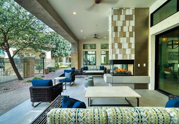 A patio with a table and chairs is surrounded by a black fence at Monument, Arizona 85224