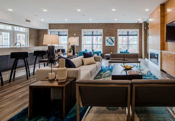 a living room with a couch and a table at The Foundry Apartments , South Bend, IN