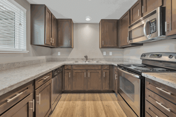 a kitchen with wooden cabinets and stainless steel appliances