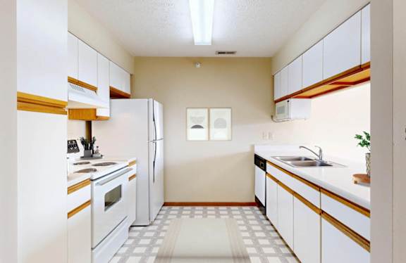 A kitchen with white appliances and wooden accents.