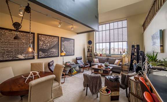 A room with a pool table and a television.