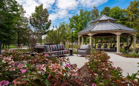 a gazebo in a park with flowers in the foreground  at Ascent at Farmington Hills, Michigan, 48331