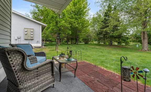 A patio with a chair and table is shown.