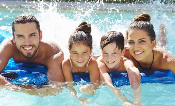 a family in the water in a swimming pool