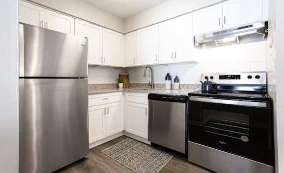 A modern kitchen with a stainless steel refrigerator and oven at Barcelo at East Cobb Apartments, GA, 30067
